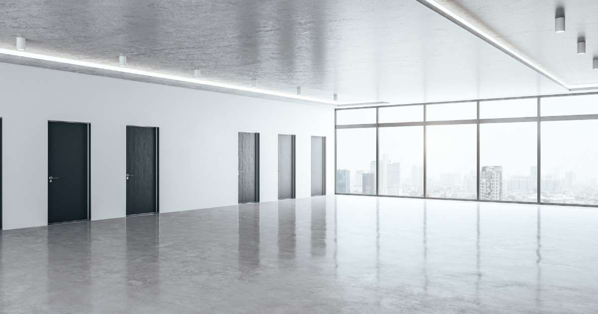black and white empty office with polished concrete floors 
